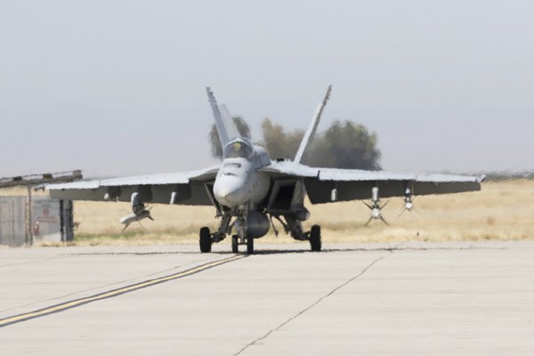 An NAS Lemoore Navy Hornet  on the tarmac at the station's flight line.